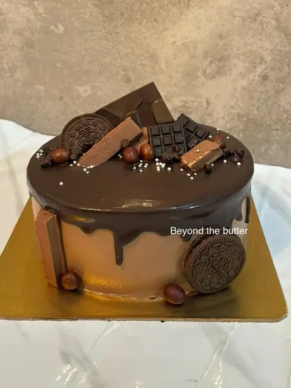 A chocolate lover's dream. This cake is loaded with chocolate drip, Oreo cookies, chocolate bars, and hazelnuts for a variety of textures and flavors.
