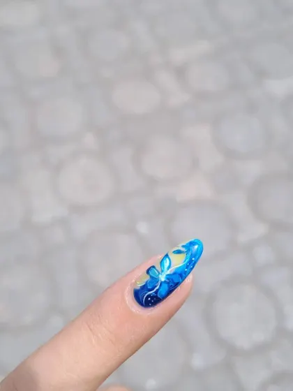A close-up of a beautiful, translucent blue flower design. The layers of color give it a lovely depth.