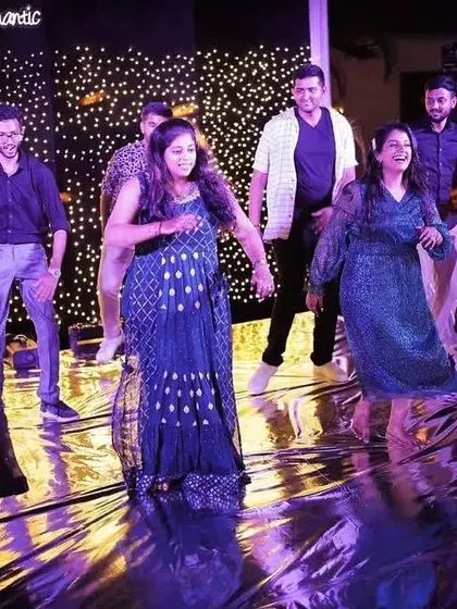 A fun group dance with cousins at a sangeet party. The reflective dance floor adds an extra layer of sparkle to the performance.