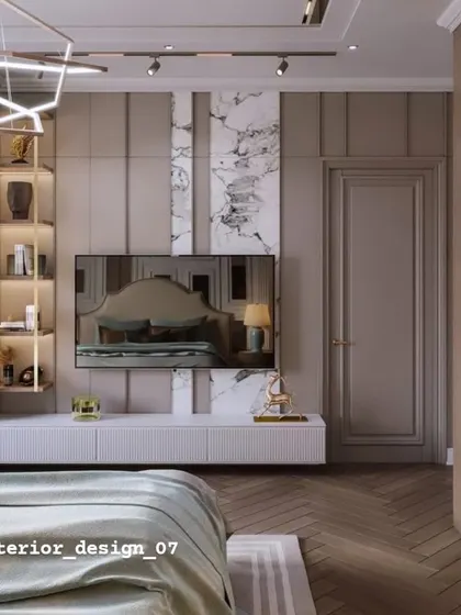 An elegant TV wall in a bedroom, combining vertical wood paneling with a marble accent. The floating white console and illuminated display shelf add to the sophisticated feel.