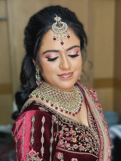 A serene portrait of the bride. The soft, blended makeup and elegant hairstyle create a look of timeless beauty.