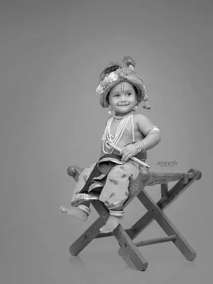 A timeless black and white version of the Krishna portrait. This artistic choice highlights the expression and details of the costume without the distraction of color.
