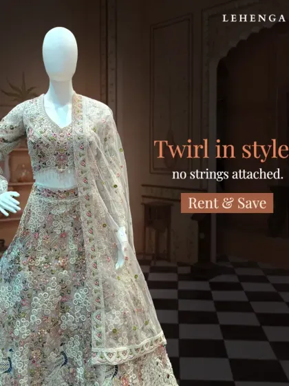 A full view of a stunning floral embroidered lehenga on a mannequin. The intricate, multi-colored threadwork on the light base makes this a sophisticated choice for any wedding event.