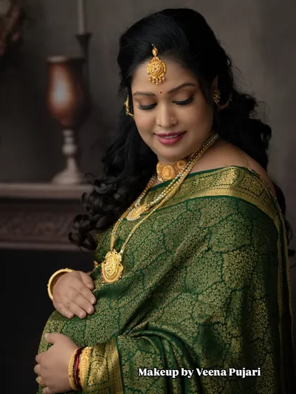 A close-up capturing the serene beauty of pregnancy. The soft makeup and traditional attire make this a truly special portrait.