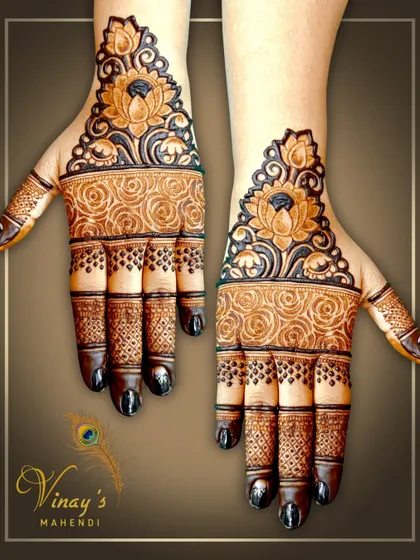 A simple yet stunning design focusing on a bold lotus cuff at the wrist, with detailed rose patterns on the palm.