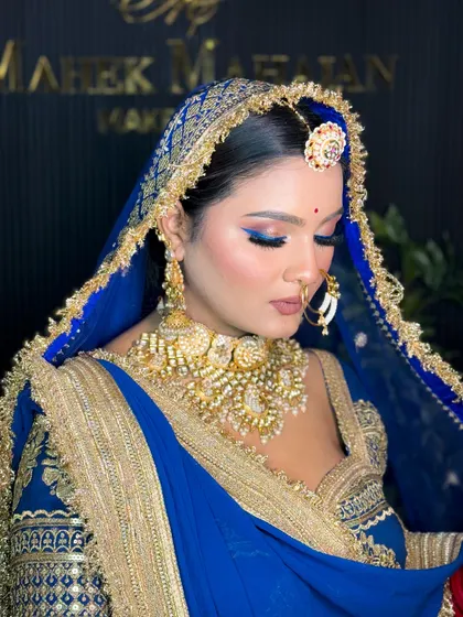A serene portrait of the Rajputi bride with her eyes closed, showcasing the dramatic blue eyeliner.