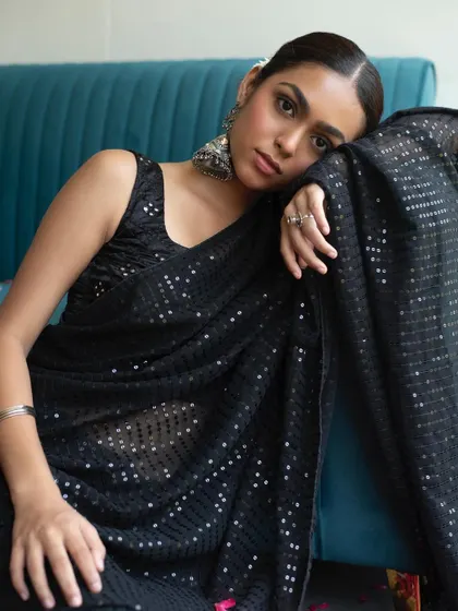 A modern ethnic look with a boho twist. I paired a minimal, dewy makeup look with a sleek low bun to complement the black sequin saree and oxidized silver jewelry.