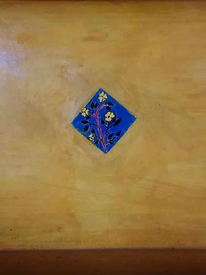 Another example of the beautiful, permanent art created by students. This floral tile adds a touch of handmade beauty to the school's architecture, a lasting legacy of their creativity.