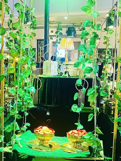 Another view of our green and gold themed buffet setup. The hanging ivy and warm lighting create an enchanting forest-like ambiance for your guests.