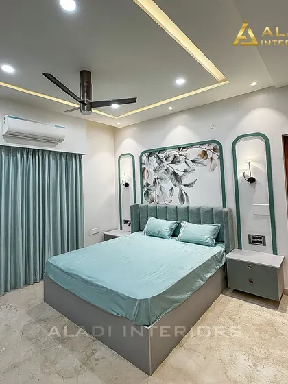A wider perspective of the green-themed bedroom, showing the interplay between the headboard design, the false ceiling lights, and the matching curtains.