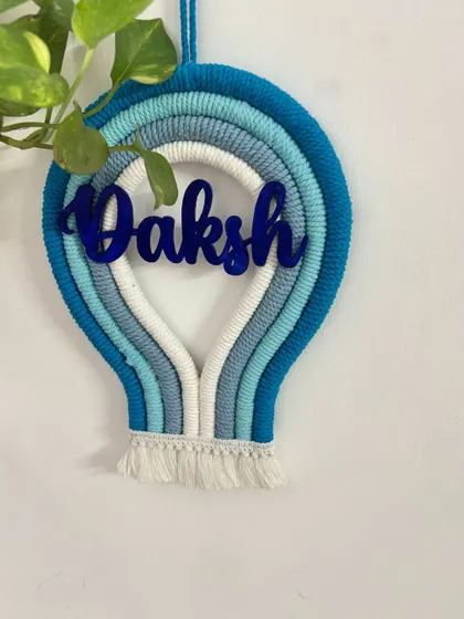 A clear, straight-on shot of the 'Daksh' parachute name hanging, perfect for seeing the full design and color combination.