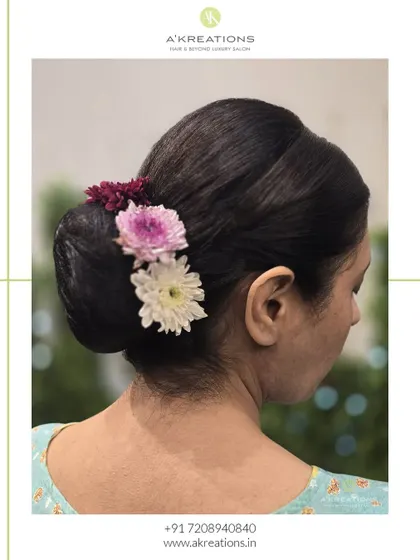A side view of the floral bun, showing how the flowers are carefully placed to create a beautiful and balanced look from every angle.