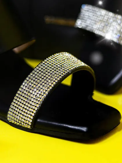 This detailed shot of a Dressberry sandal highlights the sparkling strap and sleek design. I use bold, contrasting colors and sharp lighting to create striking e-commerce and fashion accessory images that grab attention.