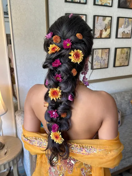 Another close-up of the beautiful Haldi braid, showing the interplay of colors from the fresh flowers against the dark hair.