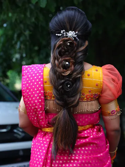 Another view of this creative bridal hairstyle. This rose-patterned braid is a true work of art, showing how we can customize your hair to be as unique as you are.