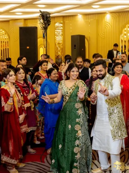 The couple dancing with their family and friends, capturing the joyous and communal spirit of the Mehndi.