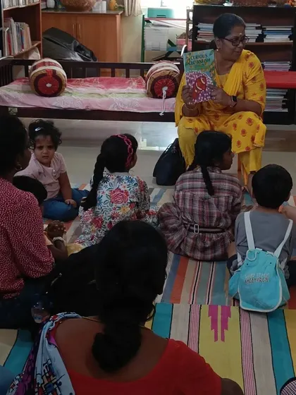 Children and parents sit together, listening to a story about protecting oneself from danger. We choose stories with important life lessons presented in an age appropriate way.