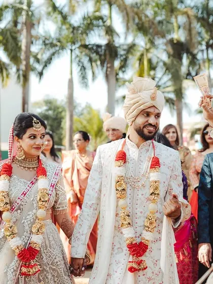 The couple's grand entrance to their wedding ceremony, with the baraat band adding to the festive atmosphere.