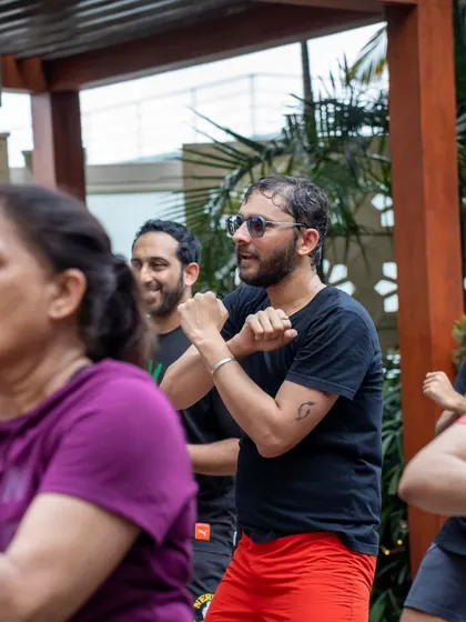 Close-up on participants concentrating on the moves. Even in a fun session, there's a focus on getting the movements right to maximize the fitness benefits.