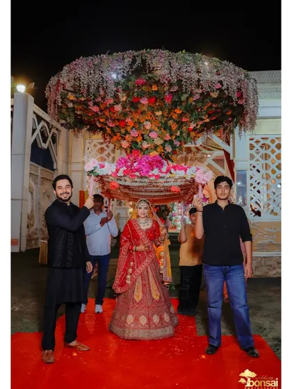 The bride's entry in a beautiful floral doli, a traditional and elegant choice.