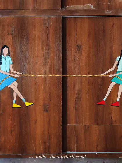 A full view of the 'Tug of War' mural. The design cleverly uses the two sliding doors of the wardrobe to create a dynamic and interactive scene.