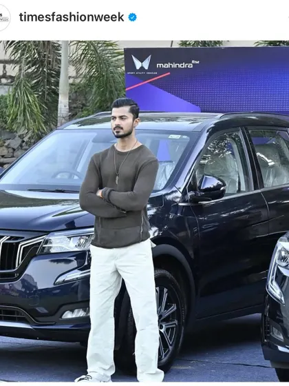 Another shot from the Mahindra promotional campaign, showcasing the car's sleek design and my complementary fashion look.