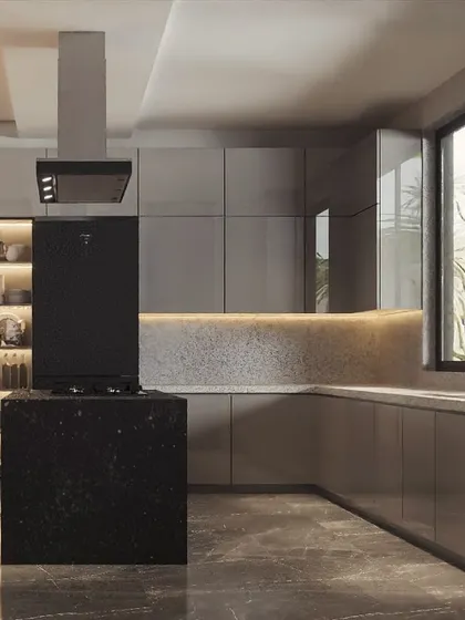 A stunning island kitchen designed for a modern home. The black granite island provides a bold centerpiece, while the grey cabinets and terrazzo-style backsplash with under-cabinet lighting create a sophisticated look.