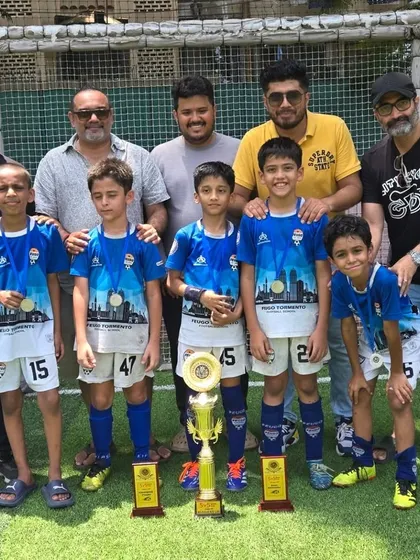 Our U-9 champions with their proud parents and coaches, celebrating a tournament victory together.