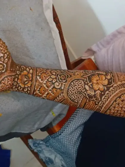 A full arm design featuring a peacock motif blended with floral and traditional Indian patterns.