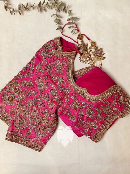 A flat lay of the pink raw silk blouse, a true showstopper.