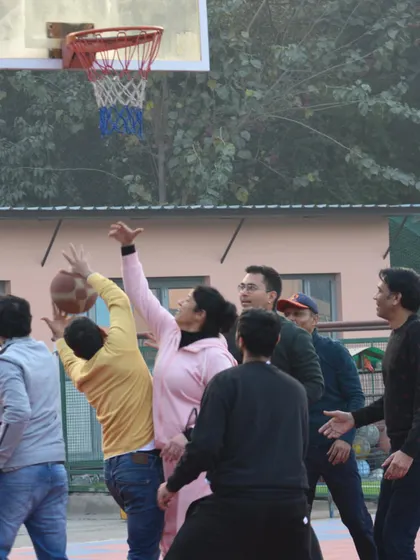 A parent goes up for a shot during the match. These events prove that it's never too late to play and have fun with sports.