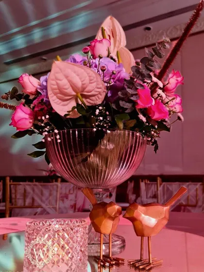 For this whimsical garden reception, we used glowing LED dragonflies and birds nestled among pastel floral arrangements. These unique lighting elements added a touch of magic and sophistication to the decor.