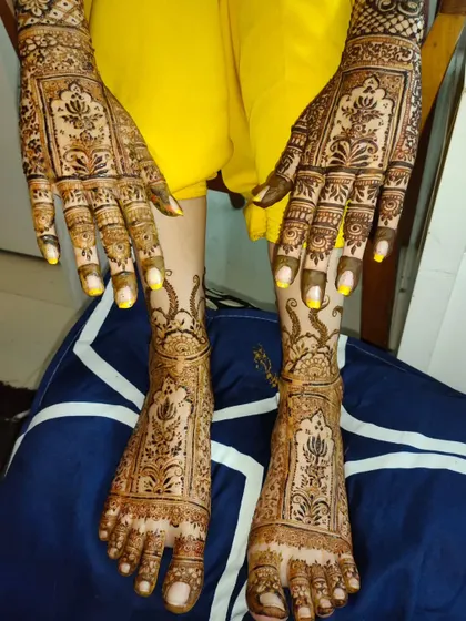 Another look at a complete bridal mehndi set. The intricate patterns on the hands are perfectly complemented by the detailed designs on the feet.