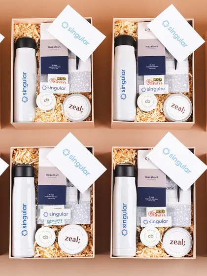 An assembly line of welcome kits for Singular. This view shows our capacity to produce large quantities of high-quality, uniform gift hampers.
