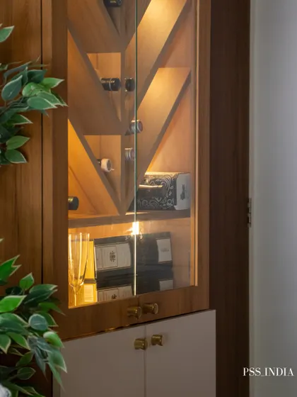Delicate accents are the quiet details that make a space feel complete. This beautifully lit bar cabinet showcases how curated objects, like glassware and decorative boxes, can turn storage into a stylish display.