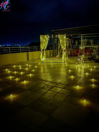 We transform any rooftop into a private, romantic escape with our cabana dinner setups. This arrangement features a beautifully draped cabana, string lights, and dozens of electric candles for a perfect evening under the stars.