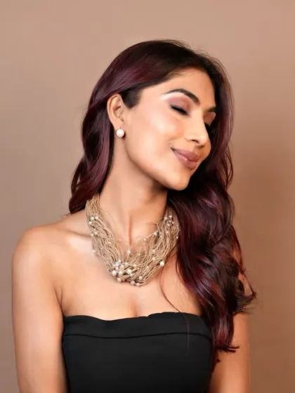 A glamorous shot of the crimson hair, styled for an evening look. The color is both powerful and feminine.
