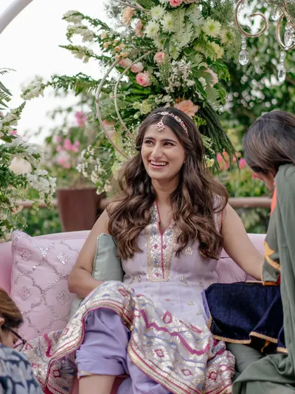 A candid shot of Sneha at her intimate Mehendi function. We chose this Gopi Vaid outfit because its colors matched the 'cotton candy skies' theme perfectly.
