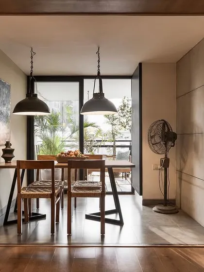 A framed view of the dining area in the 'Reweave Stories' project. We converted the original dining space into a cozy sitting area and moved the dining table to an enclosed verandah to create a more intimate eating experience.