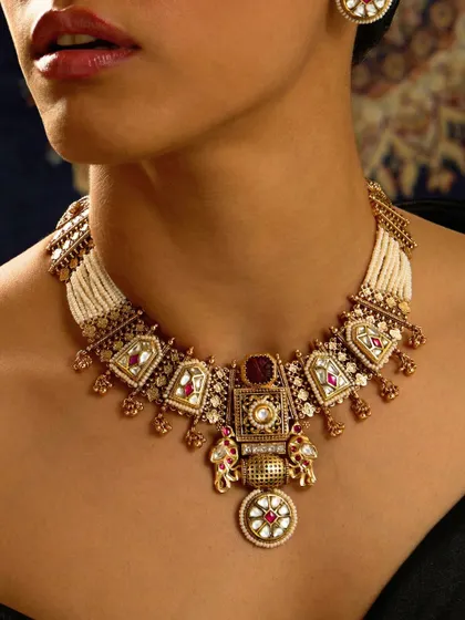 An architectural masterpiece. This intricate bridal necklace features jharokha-style motifs, tiny elephant figures, and a rich combination of polki, enamel, and pearls.