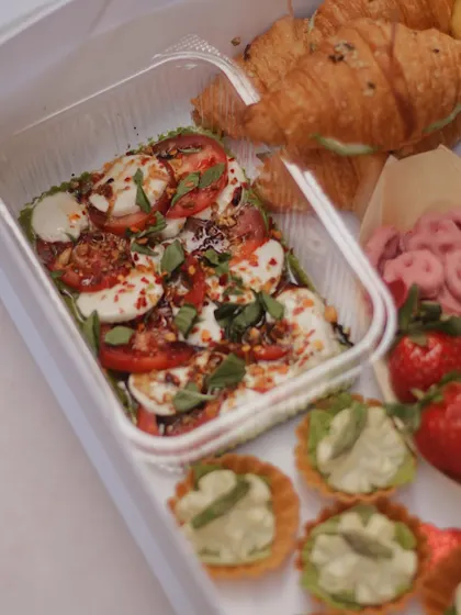 A detailed shot of the caprese salad and asparagus tarts from our Valentine's grazing box.