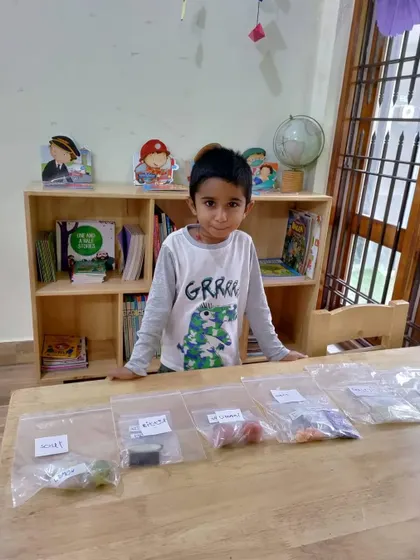A student presents his 'Types of Taste' project. This sensory activity involved tasting and identifying sweet, sour, salty, and bitter foods.