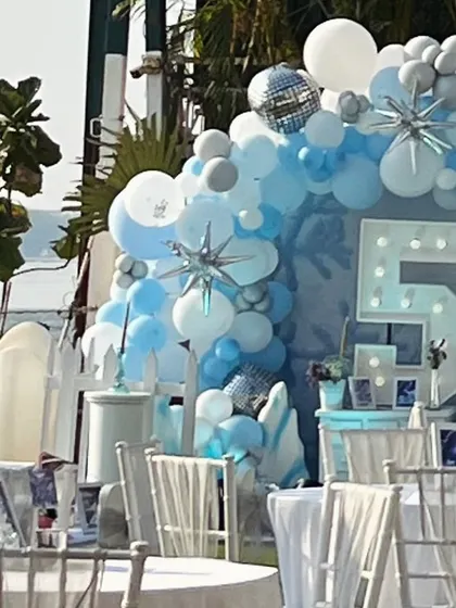 A side view of the beautiful Frozen setup, showing the layers of balloons and the lit-up number '5' for the birthday girl.