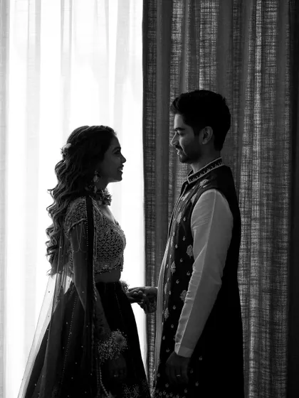 A beautiful silhouette of the couple against a bright window. This black and white portrait is all about their connection, captured in a simple, timeless, and artistic way.