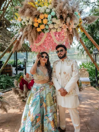 The couple looking cool and stylish at their Haldi party. The bride's makeup is fresh and radiant.