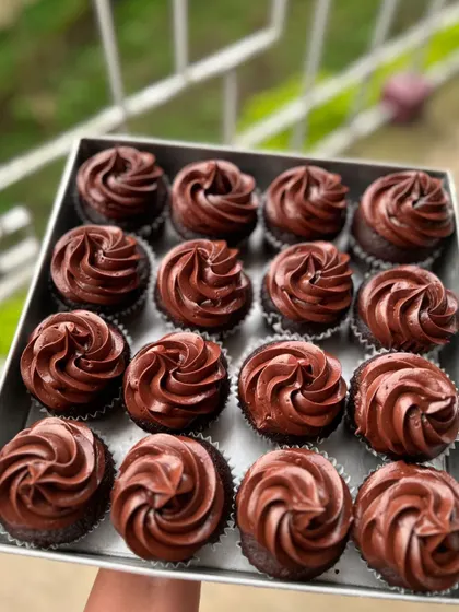 A full tray of my classic chocolate cupcakes with rich chocolate buttercream frosting.
