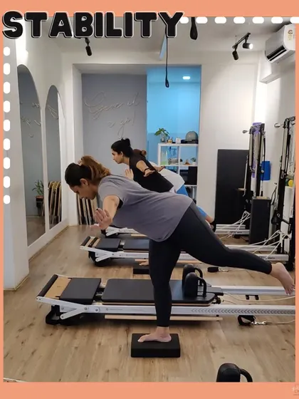 This image captures a moment of intense focus on stability. Using a block to challenge balance, this exercise strengthens the standing leg and core while promoting alignment.