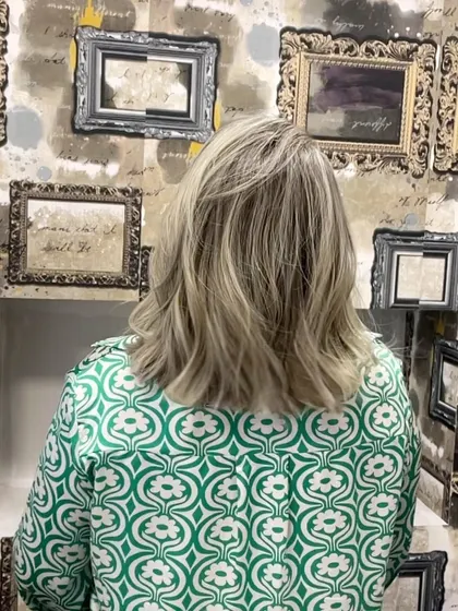 The back view of a stunning blonde, showing the seamless color work.