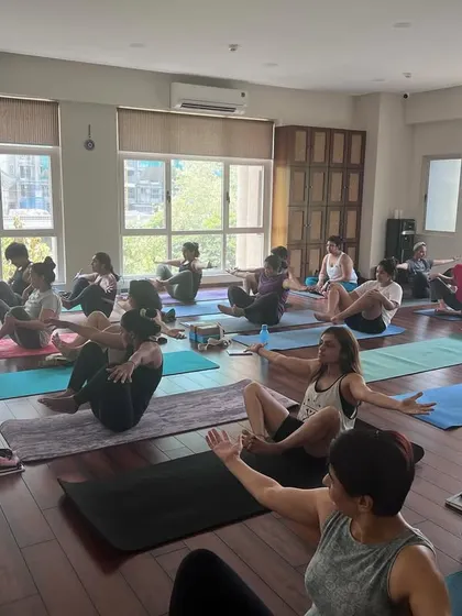 A wide shot of our studio during a workshop, showing students engaged in various stages of practice. The natural light and focused energy create a perfect learning environment.