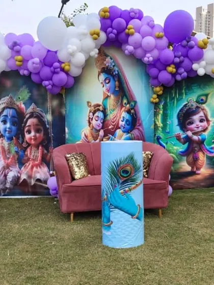 A closer look at the Krishna-themed baby shower. The vibrant backdrop and purple balloon arch create a beautiful setting for the celebration.